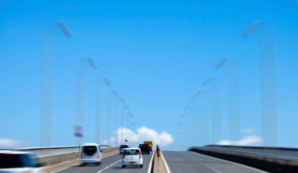 Cars driving on bridge under clear blue sky-img Cars driving on bridge under clear blue sky-img