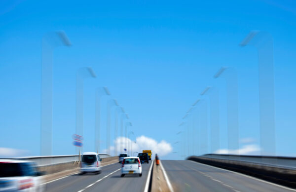 Cars driving on bridge under clear blue sky-img Cars driving on bridge under clear blue sky-img